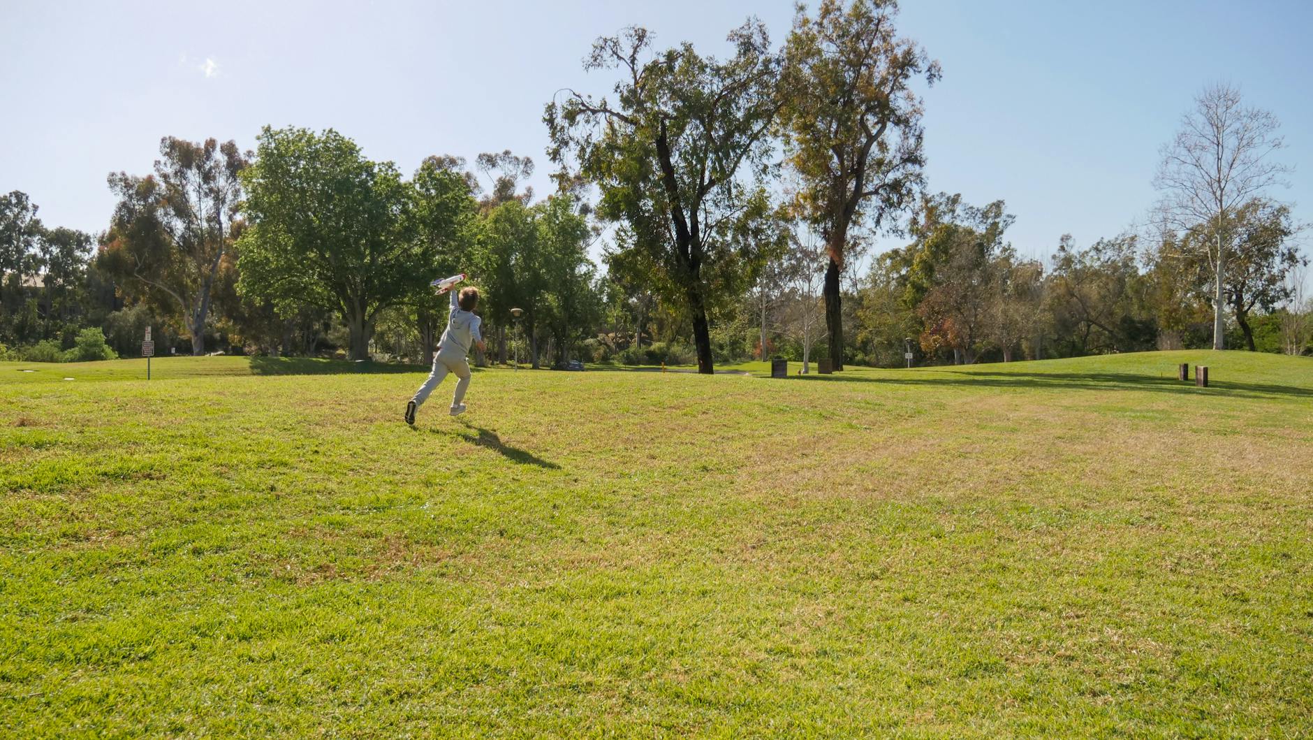 a person running on green grass field